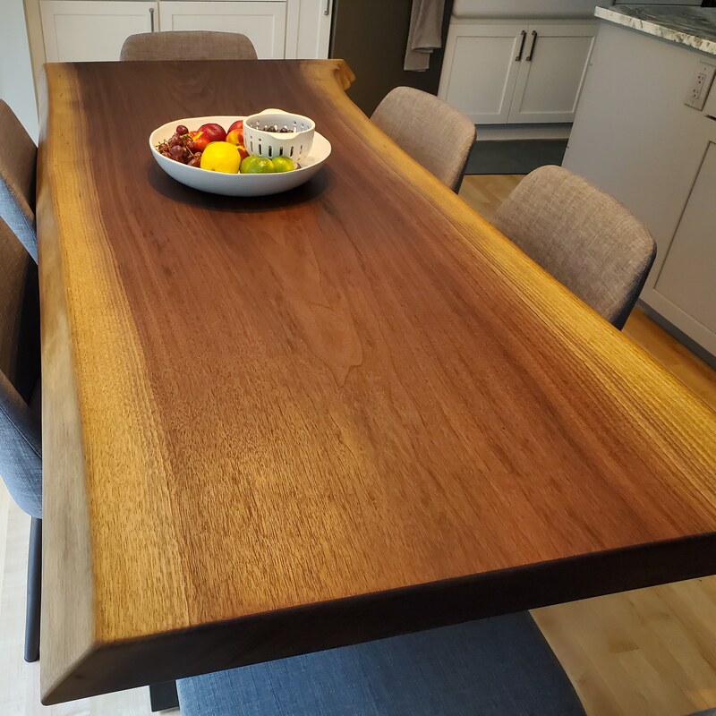Live-edge walnut dining table with a fruit bowl